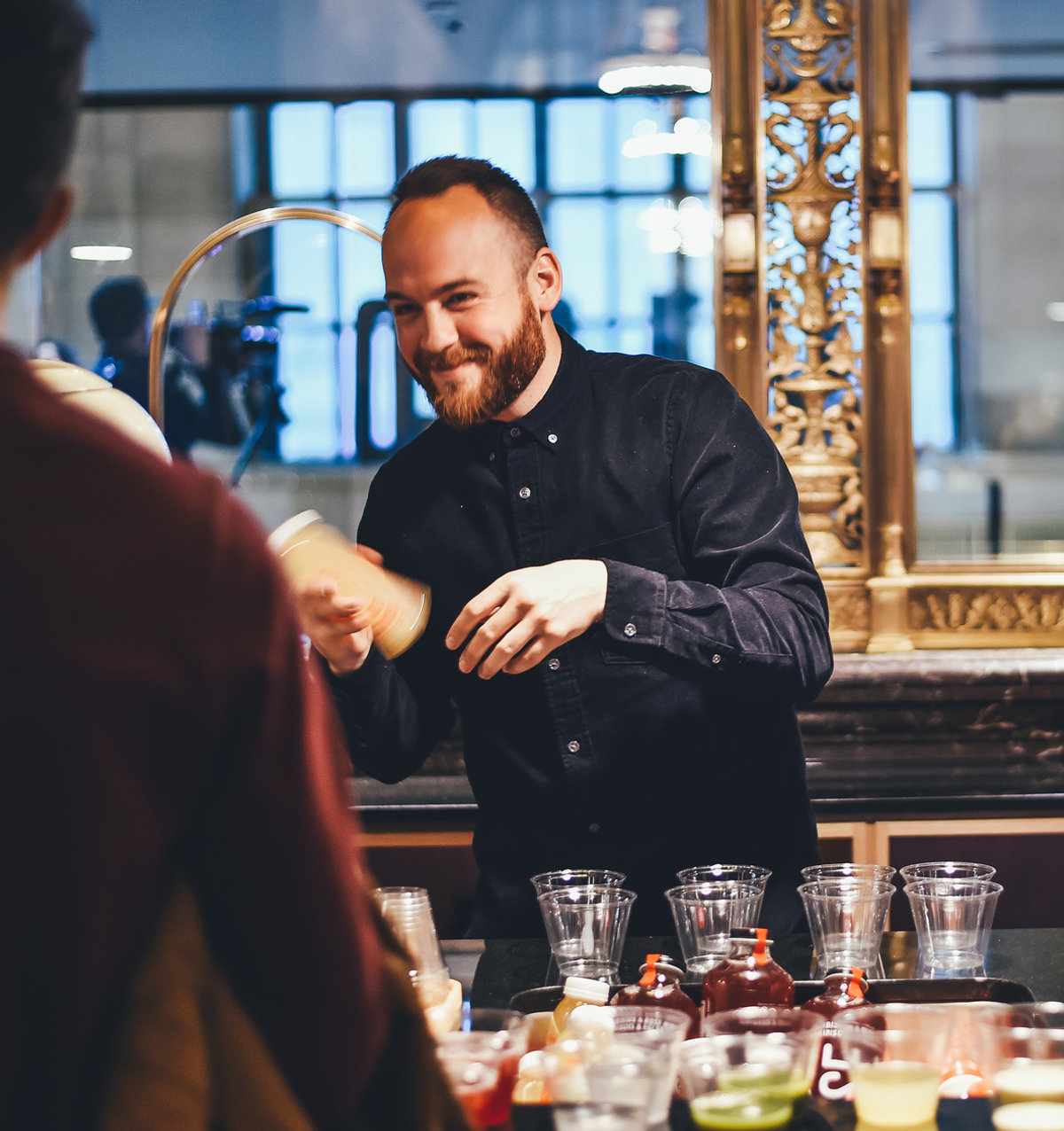 Insured bartender pouring drinks at a staffed holiday event bar