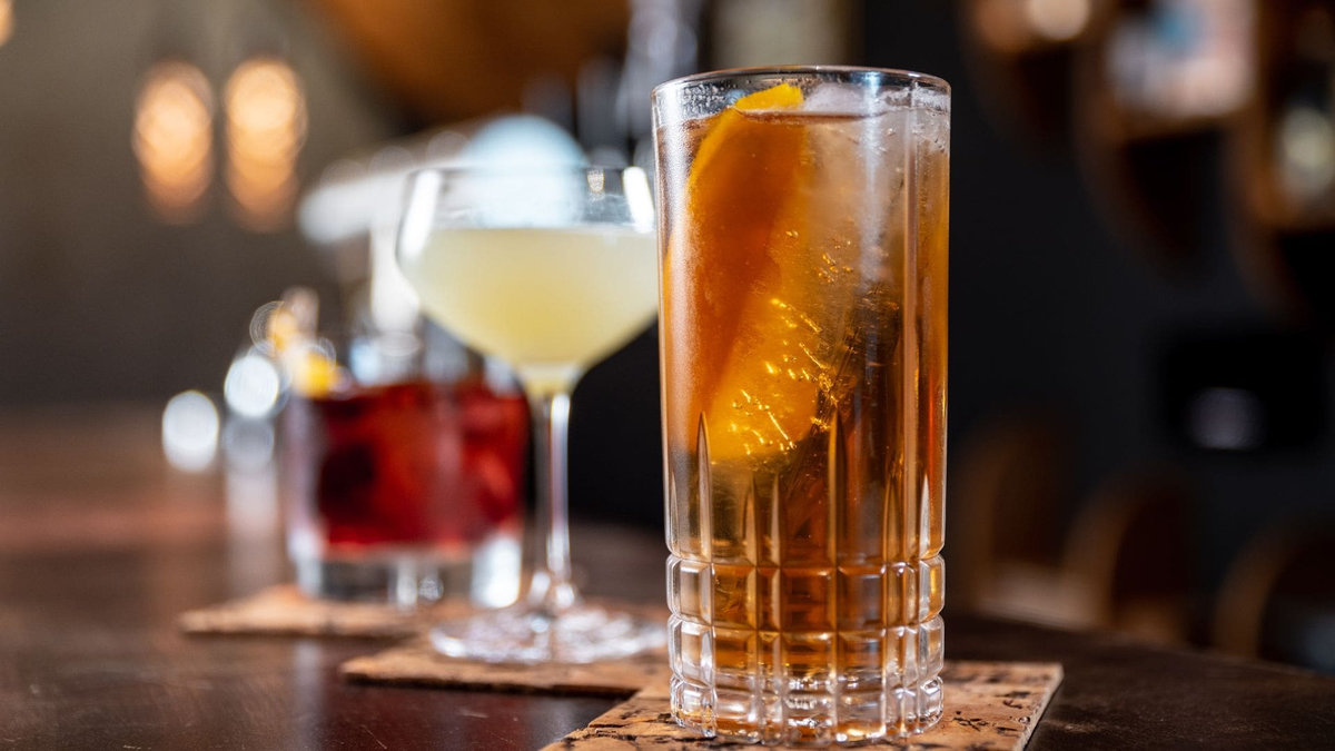 Craft cocktails from a professional event bar service on a wood bar top